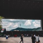 a group of people walking under a bridge