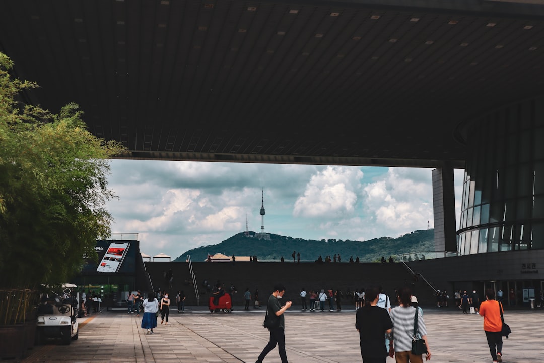 a group of people walking under a bridge
