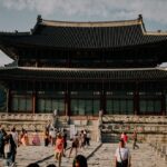 People visiting a traditional korean palace building